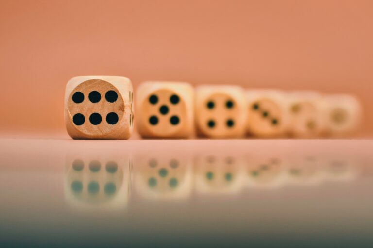 wooden dices with dot like numbers on brown background
